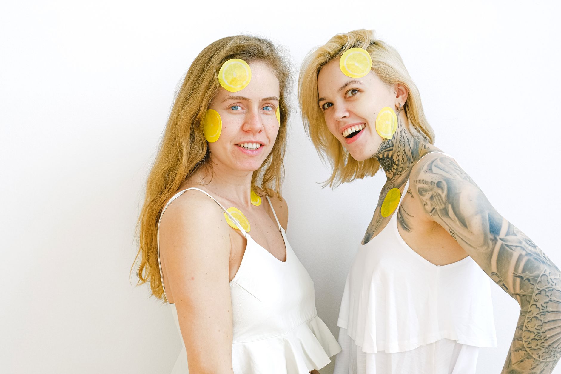Yellow silicone vibrator surrounded by fresh bananas on bright yellow background