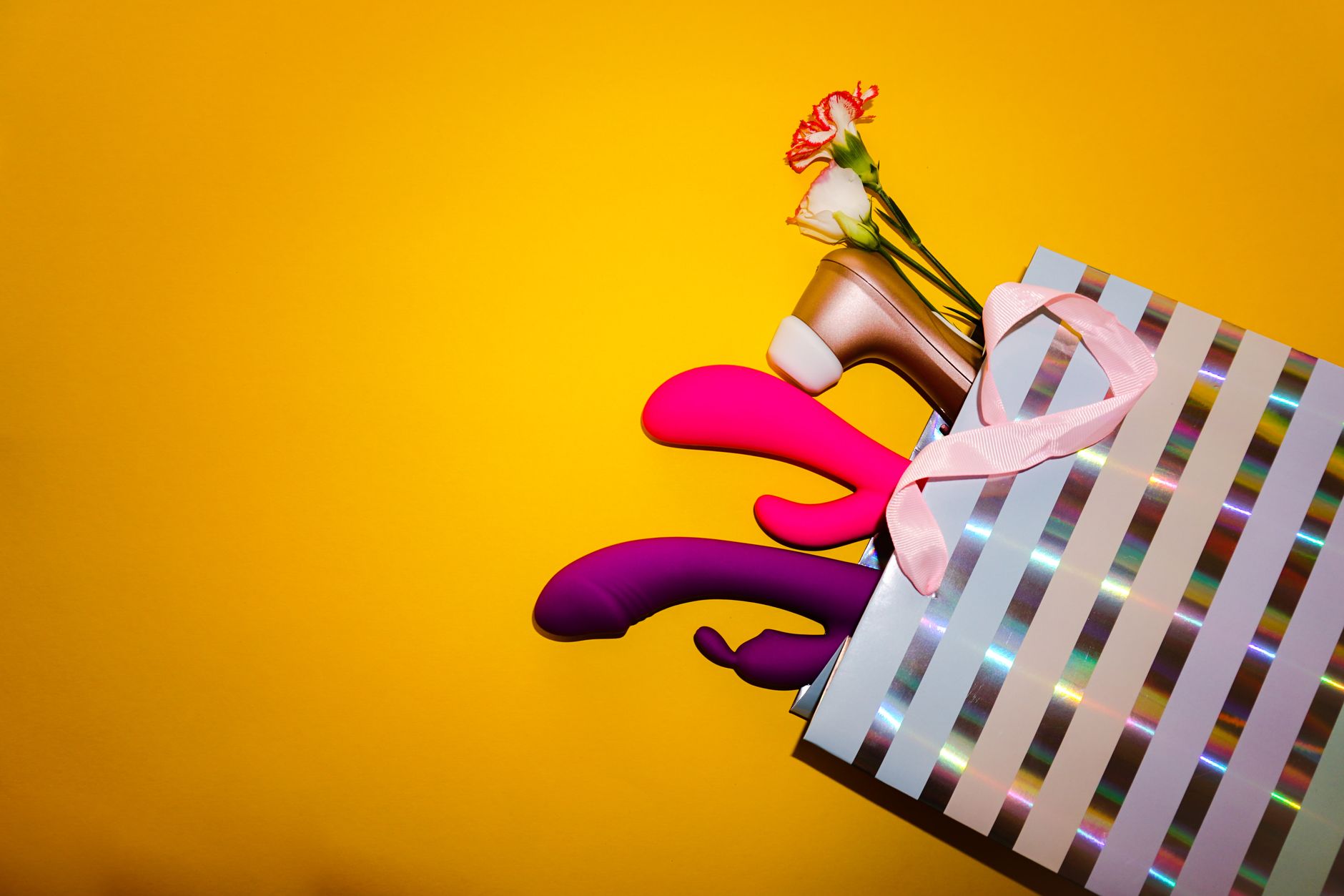 A couple holding a vibrator together, representing shared pleasure and intimate exploration.