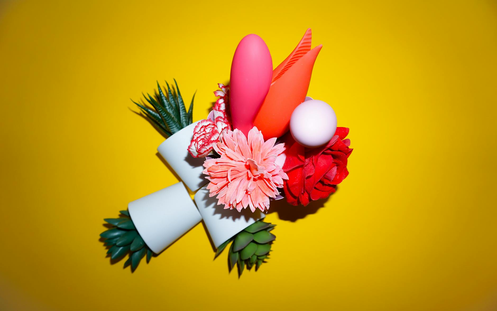 Colorful clitoral vibrators displayed together on a bright background