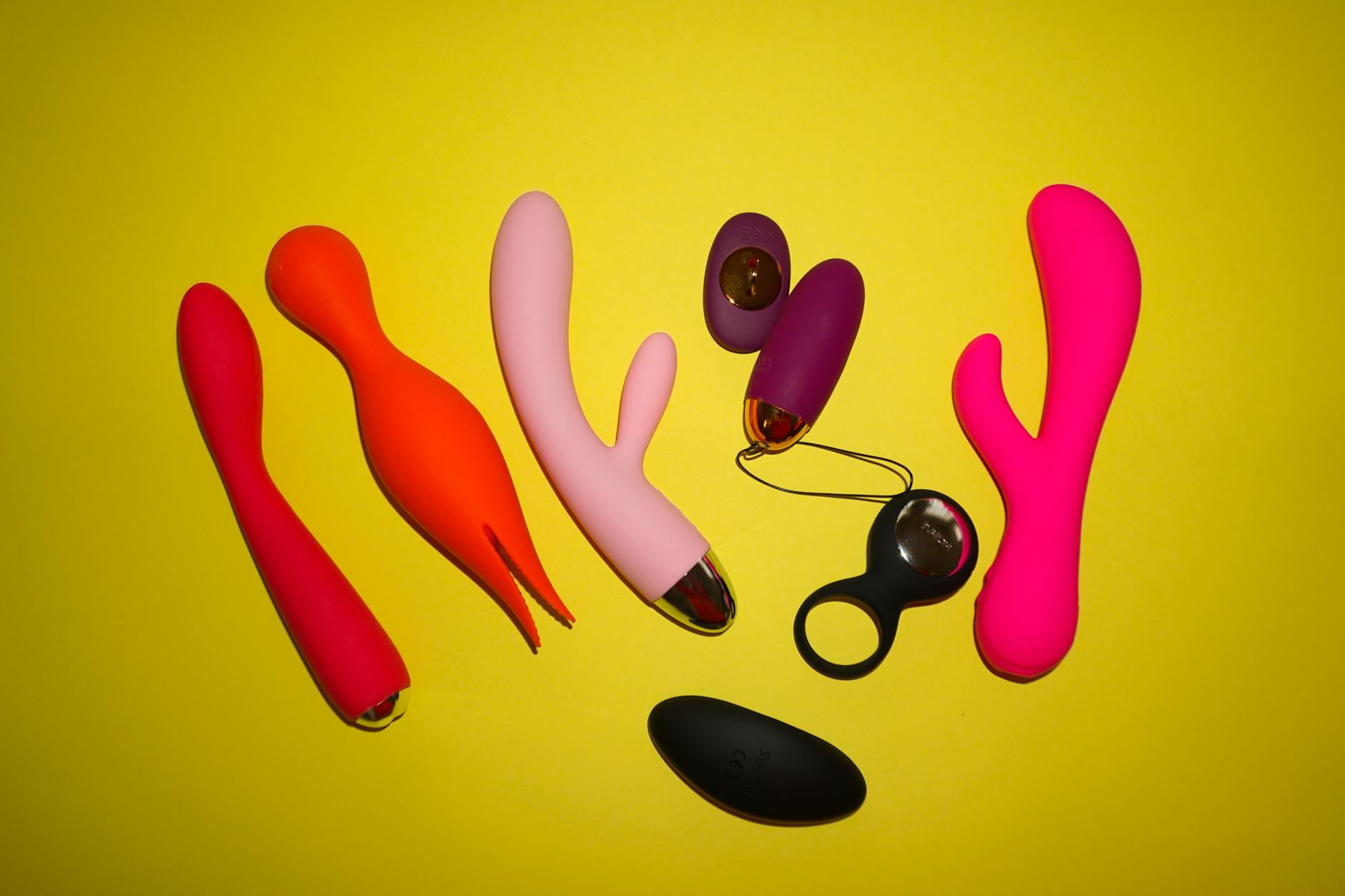 Close-up of hands holding a sleek blue vibrator, representing intimate exploration with awareness